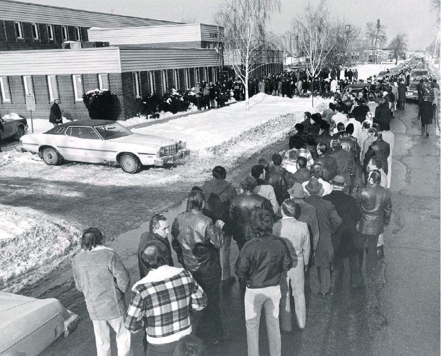 Large group of people attending a memorial service for Charles Brooks in the winter.